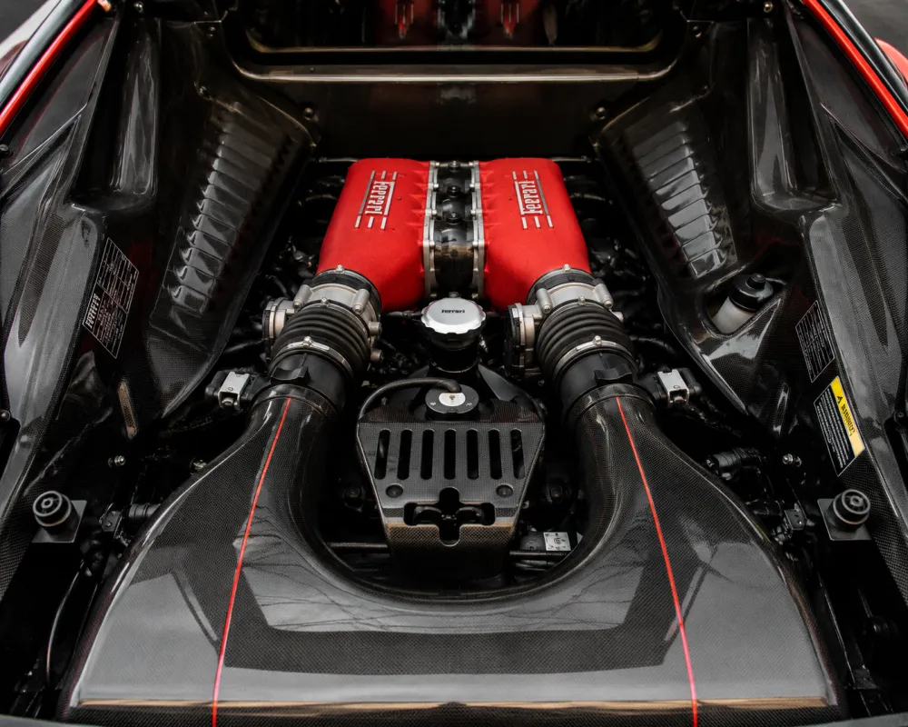 Ferrari 458 Scuderia inspired engine bay with exposed performance components, carbon fiber details, and luxury sports car mechanical craftsmanship